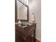 A powder room vanity with a dark wood finish and modern mirror at 3951 Lorien Nw Way, Kennesaw, GA 30152
