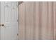 Bathroom with white door and a light pink shower curtain with horizontal stripes at 3951 Lorien Nw Way, Kennesaw, GA 30152