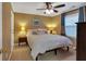 Cozy bedroom with a ceiling fan, natural light and a comfortable bed with a neutral color palette at 3951 Lorien Nw Way, Kennesaw, GA 30152