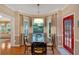 A dining room with a round table, chairs, and natural light from the windows at 3951 Lorien Nw Way, Kennesaw, GA 30152