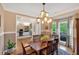 Inviting dining room featuring hardwood floors, chair rail detail, and a stylish chandelier at 3951 Lorien Nw Way, Kennesaw, GA 30152