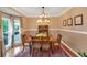 Bright dining area with hardwood floors, large window, and tasteful decorative art at 3951 Lorien Nw Way, Kennesaw, GA 30152
