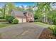 Charming two-story brick home with an attached two-car garage and well-kept front lawn and driveway at 3951 Lorien Nw Way, Kennesaw, GA 30152