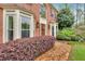 Beautiful red brick home featuring bay windows, decorative shutters, and well-maintained landscaping at 3951 Lorien Nw Way, Kennesaw, GA 30152