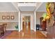 Elegant foyer with hardwood floors, decorative trim, and a clear view into the dining and living areas at 3951 Lorien Nw Way, Kennesaw, GA 30152