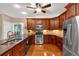 Functional kitchen with stainless steel appliances, granite countertops, and wood cabinetry at 3951 Lorien Nw Way, Kennesaw, GA 30152
