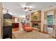 Open-concept living room with stone fireplace, hardwood floors, and natural light at 3951 Lorien Nw Way, Kennesaw, GA 30152