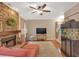 Comfortable living area featuring a stone fireplace, ceiling fan, and hardwood floors at 3951 Lorien Nw Way, Kennesaw, GA 30152