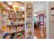 A well-stocked pantry with shelves and baskets, plus a view to dining area at 3951 Lorien Nw Way, Kennesaw, GA 30152