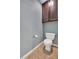 Cozy powder room with toilet, cabinet, and neutral paint at 3951 Lorien Nw Way, Kennesaw, GA 30152