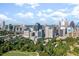 Panoramic aerial view of the Atlanta skyline and surrounding lush green canopy and residential buildings at 145 15Th Ne St # 204, Atlanta, GA 30309