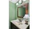 Cozy bathroom featuring a vanity with a decorative lamp, a mirror, and soft green paint for a relaxing ambiance at 145 15Th Ne St # 204, Atlanta, GA 30309