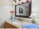 Bathroom with granite countertop vanity, sink, and large framed mirror at 145 15Th Ne St # 204, Atlanta, GA 30309