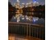 Night view of city skyline reflecting on the water, with illuminated buildings and bridge at 145 15Th Ne St # 204, Atlanta, GA 30309