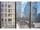 Stunning city view through a window, showcasing nearby buildings and outdoor seating at 145 15Th Ne St # 204, Atlanta, GA 30309