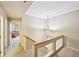 View of upstairs hallway leading to rooms with staircase and hanging pendant light at 145 15Th Ne St # 204, Atlanta, GA 30309