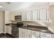 Functional kitchen features granite countertops, white cabinetry, and stainless-steel appliances for a modern cooking experience at 145 15Th Ne St # 204, Atlanta, GA 30309