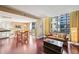 Bright living room with hardwood floors, large windows, and a comfortable sofa perfect for relaxing and entertaining at 145 15Th Ne St # 204, Atlanta, GA 30309