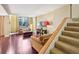 Bright living room features hardwood floors, large windows and staircase at 145 15Th Ne St # 204, Atlanta, GA 30309