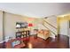 Comfortable living area with hardwood floors, a cozy armchair, and a staircase leading to upper level, ready to enjoy at 145 15Th Ne St # 204, Atlanta, GA 30309