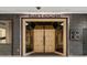 The entrance to Rumi's Kitchen with unique rustic wooden double doors and stylish brick walls at 145 15Th Ne St # 204, Atlanta, GA 30309