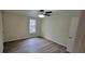 Spacious bedroom with ceiling fan, window, and wood-look flooring at 1701 Augusta Se Dr # 1701, Marietta, GA 30067