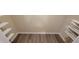 Spacious walk-in closet with durable wood-look flooring and convenient adjustable shelving at 1701 Augusta Se Dr # 1701, Marietta, GA 30067