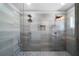 Modern bathroom featuring a glass-enclosed shower with dual shower heads and stylish gray tiling at 1732 Red Maple Rdg, Atlanta, GA 30316