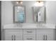 Elegant bathroom with dual sinks, white cabinets, and illuminated mirrors at 1732 Red Maple Rdg, Atlanta, GA 30316