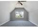 Carpeted bedroom with an angled ceiling and a large window with view at 1732 Red Maple Rdg, Atlanta, GA 30316