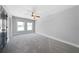 Spacious bedroom featuring plush carpeting, two windows, and a ceiling fan at 1732 Red Maple Rdg, Atlanta, GA 30316