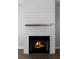 Contemporary fireplace with modern mantel and white shiplap surround at 1732 Red Maple Rdg, Atlanta, GA 30316