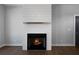 Cozy fireplace with a white shiplap surround and a black firebox at 1732 Red Maple Rdg, Atlanta, GA 30316