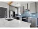 Modern kitchen with stainless steel appliances, blue backsplash, and a large white marble island at 1732 Red Maple Rdg, Atlanta, GA 30316