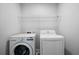 Neat laundry room with a washer, dryer, and overhead storage shelf at 1732 Red Maple Rdg, Atlanta, GA 30316