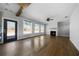 Open living room with hardwood floors, a fireplace, and large windows providing natural light at 1732 Red Maple Rdg, Atlanta, GA 30316