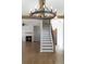Open-concept living room with hardwood floors and fireplace adjacent to staircase at 1732 Red Maple Rdg, Atlanta, GA 30316