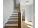 Bright staircase featuring hardwood steps and flooring leading to the upper level at 1732 Red Maple Rdg, Atlanta, GA 30316