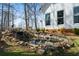 Landscaped backyard features a scenic pond with waterfall, rock accents, and ample space to roam at 680 Milligan Creek Rd, Roopville, GA 30170