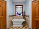 Charming bathroom featuring a clawfoot tub, tiled walls, and stained glass at 680 Milligan Creek Rd, Roopville, GA 30170