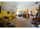 Large bonus room with neutral carpeting, wood accents, and bright yellow walls perfect for entertaining at 680 Milligan Creek Rd, Roopville, GA 30170