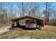 Open carport structure with a vintage truck parked inside at 680 Milligan Creek Rd, Roopville, GA 30170