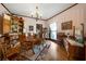 Charming dining room featuring wood floors, decorative china cabinet, and a vintage chandelier at 680 Milligan Creek Rd, Roopville, GA 30170