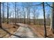 Long private driveway winding through mature trees, offering a secluded entrance to the property at 680 Milligan Creek Rd, Roopville, GA 30170
