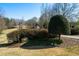 Welcoming property entrance with stone pillars, mature landscaping and clearly marked address for easy identification at 680 Milligan Creek Rd, Roopville, GA 30170