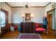 Charming entryway featuring hardwood floors, decorative wallpaper, vintage furniture, and natural light at 680 Milligan Creek Rd, Roopville, GA 30170