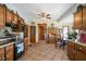 Spacious kitchen with wooden cabinets, dining area, and tile floors, blending style and functionality at 680 Milligan Creek Rd, Roopville, GA 30170