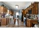 Functional kitchen with wooden cabinetry, tile flooring, and modern appliances at 680 Milligan Creek Rd, Roopville, GA 30170
