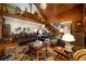 Inviting living room featuring a loft, wood accents, plush furniture, and warm natural light at 680 Milligan Creek Rd, Roopville, GA 30170