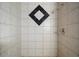 Ceramic tile shower featuring a black diamond accent, and shiny chrome fixtures at 680 Milligan Creek Rd, Roopville, GA 30170